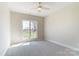 Bright bedroom featuring a large window with views of the outside and soft, neutral carpeting at 3432 Greene Rd, Monroe, NC 28110