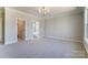 Spacious bedroom featuring a chandelier, neutral walls, carpet, and access to the bathroom at 3432 Greene Rd, Monroe, NC 28110