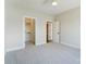 Neutral bedroom featuring soft carpet, a ceiling fan, and a closet and another room at 3432 Greene Rd, Monroe, NC 28110