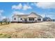 New construction home exterior with white siding, covered patio, and big backyard at 3432 Greene Rd, Monroe, NC 28110