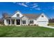 Inviting one-story home with stone and white siding, green shutters, a covered front porch, and a lush green lawn at 3432 Greene Rd, Monroe, NC 28110