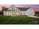 Charming one-story home features a combination of stone and vinyl siding, green shutters, and a well-manicured lawn at 3432 Greene Rd, Monroe, NC 28110
