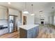 Eat-in kitchen island featuring a stainless fridge and hardwood floors at 3432 Greene Rd, Monroe, NC 28110