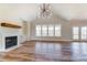 Spacious living room with high ceilings, wood floors, a fireplace, built-in cabinets, and large windows at 3432 Greene Rd, Monroe, NC 28110