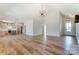 Open living space showcasing wood floors, a kitchen, and a cozy fireplace, perfect for entertaining at 3432 Greene Rd, Monroe, NC 28110