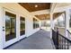 Covered patio with stained ceiling, fan, and French doors at 3432 Greene Rd, Monroe, NC 28110