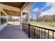 Covered patio with wood ceiling, fan, and views at 3432 Greene Rd, Monroe, NC 28110