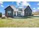 Gray brick two-story house with white accents and a welcoming front porch at 3436 Greene Rd, Monroe, NC 28110