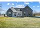 Modern farmhouse exterior boasts gray brick, white accents, and a charming front porch at 3436 Greene Rd, Monroe, NC 28110