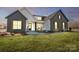 Two-story home with gray brick and white accents, welcoming front porch, and landscaped lawn at 3436 Greene Rd, Monroe, NC 28110