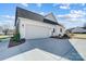 White garage with driveway and landscaping at 3436 Greene Rd, Monroe, NC 28110