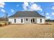 White house back, gray roof, covered patio, and small yard at 3436 Greene Rd, Monroe, NC 28110