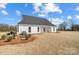 White house back, gray roof, covered patio, landscaping, and yard at 3436 Greene Rd, Monroe, NC 28110