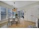 Bright breakfast nook features a glass table, chairs, and access to a sunroom at 3935 Yosemite Way, Fort Mill, SC 29707