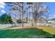 Backyard with trees and a white fence at 4005 Linville Falls Ln, Monroe, NC 28110