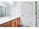 Light-toned bathroom with wood vanity, a sink, and a large mirror at 4005 Linville Falls Ln, Monroe, NC 28110