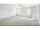 Spacious carpeted bedroom with ceiling fan and two windows at 4005 Linville Falls Ln, Monroe, NC 28110