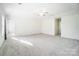 Bright and airy carpeted bedroom with ceiling fan at 4005 Linville Falls Ln, Monroe, NC 28110