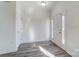 Bright and airy entryway with light grey wood-look flooring at 4005 Linville Falls Ln, Monroe, NC 28110