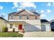 Two-story house featuring a two-car garage and red front door at 4005 Linville Falls Ln, Monroe, NC 28110