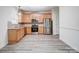 Modern kitchen with light wood cabinets and stainless steel appliances at 4005 Linville Falls Ln, Monroe, NC 28110