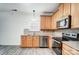 Modern kitchen with light wood cabinets, stainless steel appliances, and tile backsplash at 4005 Linville Falls Ln, Monroe, NC 28110