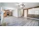 Open concept kitchen and living area with stainless steel appliances and laminate flooring at 4005 Linville Falls Ln, Monroe, NC 28110