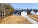 White house with gray roof, two-car garage, and driveway at 4109 Pebblebrook Sw Cir, Concord, NC 28027
