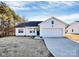 White house with a black roof and a two-car garage at 4109 Pebblebrook Sw Cir, Concord, NC 28027