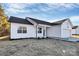 New construction home with white siding and a black roof at 4109 Pebblebrook Sw Cir, Concord, NC 28027