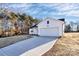 White house with a black roof and a large driveway at 4109 Pebblebrook Sw Cir, Concord, NC 28027