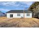 Rear view of a white house with black roof and sliding glass doors at 4109 Pebblebrook Sw Cir, Concord, NC 28027
