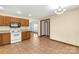 Bright kitchen with wood cabinets, white appliances, and tile floors. View of adjoining dining area at 4641 Hickory Grove Rd, Sharon, SC 29742