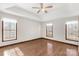 Main bedroom with hardwood floors, ceiling fan, and two windows at 4641 Hickory Grove Rd, Sharon, SC 29742