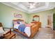 Light and airy bedroom with a wood bed frame and ceiling fan at 5517 Cyrus Lee Ln, Monroe, NC 28110