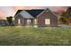 Brick ranch home with landscaped lawn and attached garage at 5517 Cyrus Lee Ln, Monroe, NC 28110