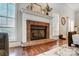Brick fireplace with white mantel in living room at 5517 Cyrus Lee Ln, Monroe, NC 28110