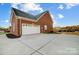 Brick home with attached two-car garage and large concrete driveway at 5517 Cyrus Lee Ln, Monroe, NC 28110