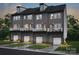 Three-story townhomes with gray siding, attached garages, and balconies at 5628 Kingspan Dr, Charlotte, NC 28217