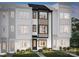 Three-story townhome with modern exterior and landscaping at 5628 Kingspan Dr, Charlotte, NC 28217