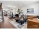 Open-concept living room boasts hardwood floors, natural light, and stylish furnishings at 5628 Kingspan Dr, Charlotte, NC 28217