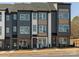 Modern townhomes showcasing a stylish exterior with mixed siding and complementary brick accents at 5628 Kingspan Dr, Charlotte, NC 28217