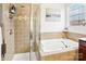 Clean bathroom with shower, tub, and updated tile at 8814 Beaver Creek Dr, Charlotte, NC 28269