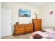 Bedroom with wood dressers and a large flat-screen TV at 8814 Beaver Creek Dr, Charlotte, NC 28269