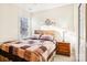 Bedroom with wood dresser, ceiling fan, and a patchwork quilt at 8814 Beaver Creek Dr, Charlotte, NC 28269