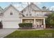 Two-story house with gray siding, brick accents, and a porch at 8814 Beaver Creek Dr, Charlotte, NC 28269