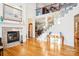 Two-story living room with hardwood floors, fireplace, and open staircase at 8814 Beaver Creek Dr, Charlotte, NC 28269