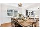 Bright dining room with farmhouse table and chandelier at 8901 Douglas Dr, Charlotte, NC 28217