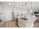 Modern kitchen with island, granite countertops, and stainless steel appliances at 917 Black Beard Dr, Denver, NC 28037