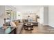 Open living room with L-shaped sectional sofa, kitchen views, and access to backyard at 917 Black Beard Dr, Denver, NC 28037